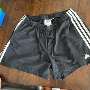 What black with white stripes pair of Adidas athletic shorts.